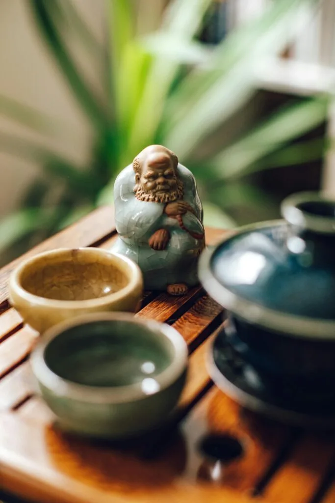 a ceramic tea pet and bowls on a table